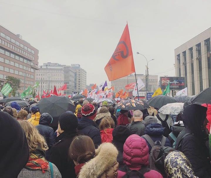 A crowd of Russian protesters march through the streets carrying flags
